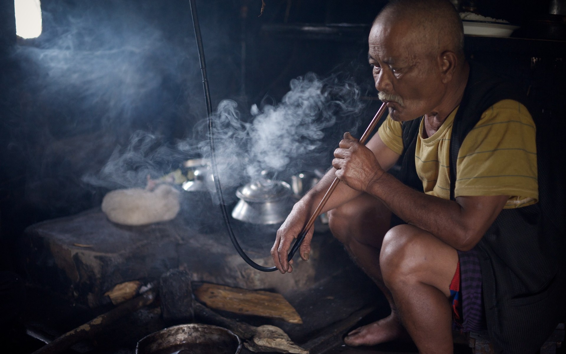 A host at his kitchen hearth in a Khasi village, Meghalaya