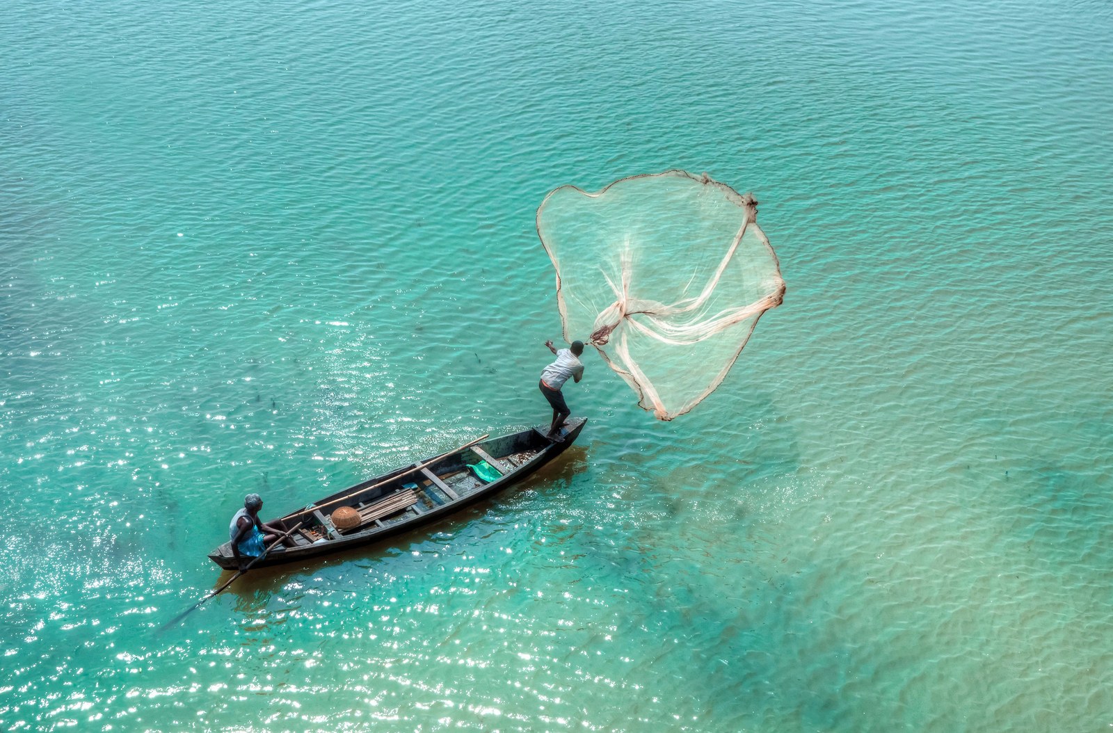 Fisherman casting a net on the Brahmaputra