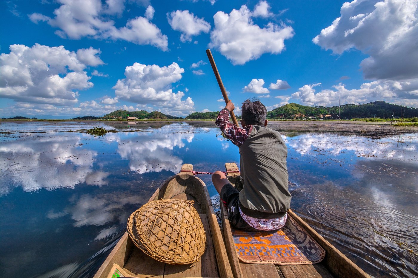 A fisherman paddling across Loktak Lake