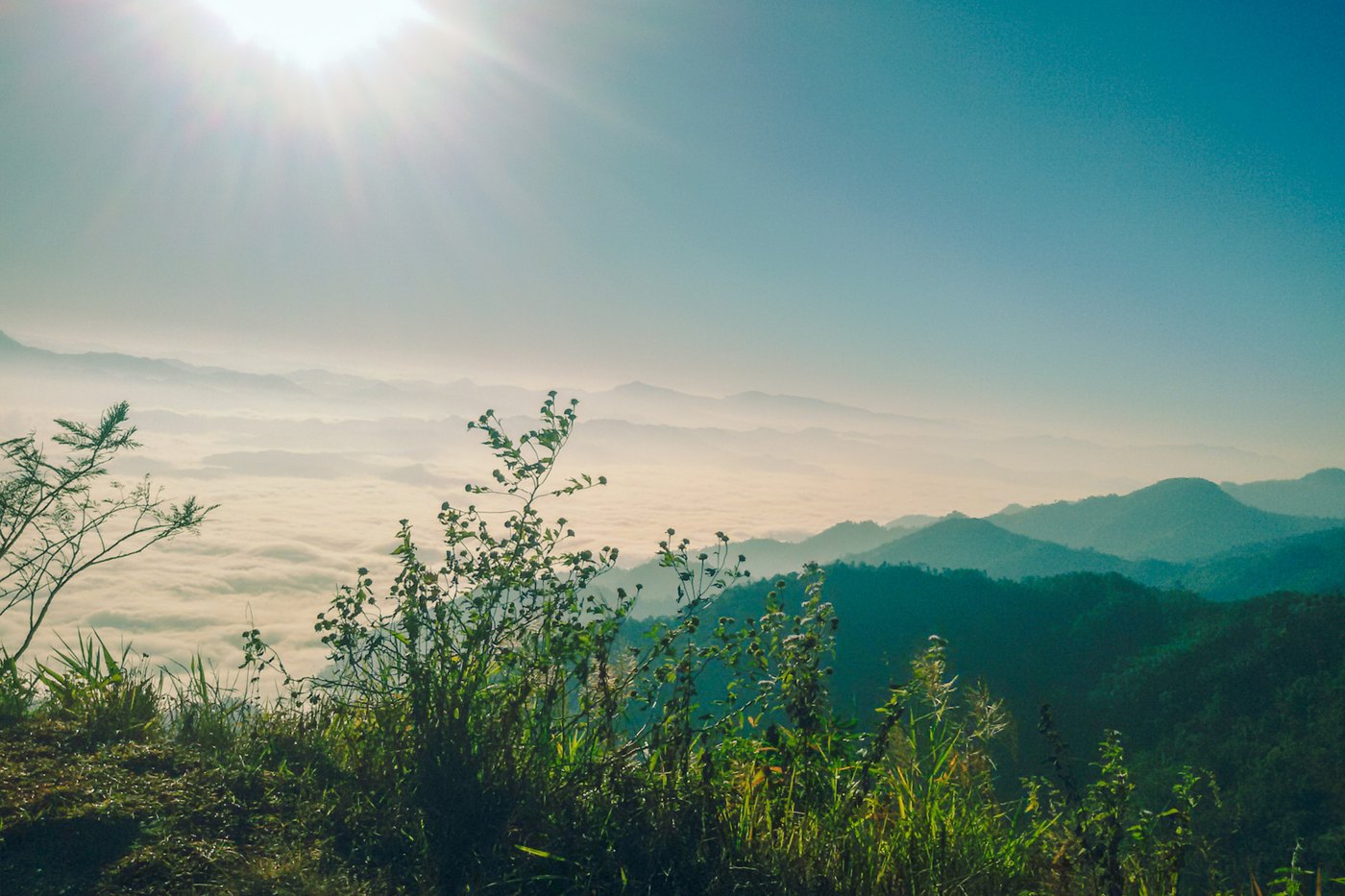 Green hills under a bright sky
