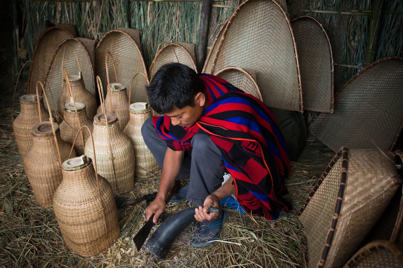 A craftsman shaping a mithun horn