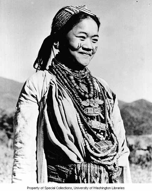 Aka woman with face paint and Tibetan ornaments, Jamiri village, ca. 1954