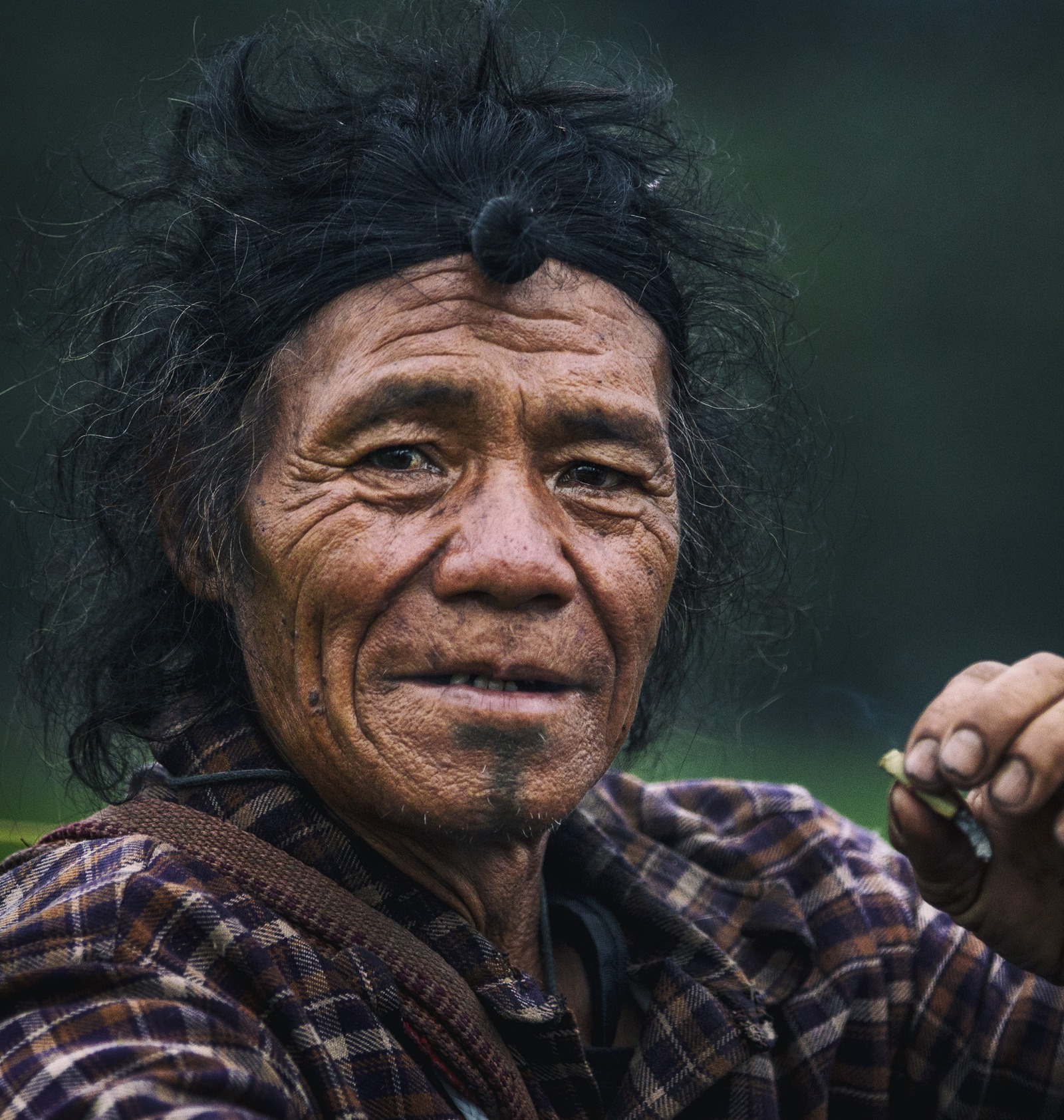 An Apatani elder with the traditional topknot and chin tattoo, Ziro Valley