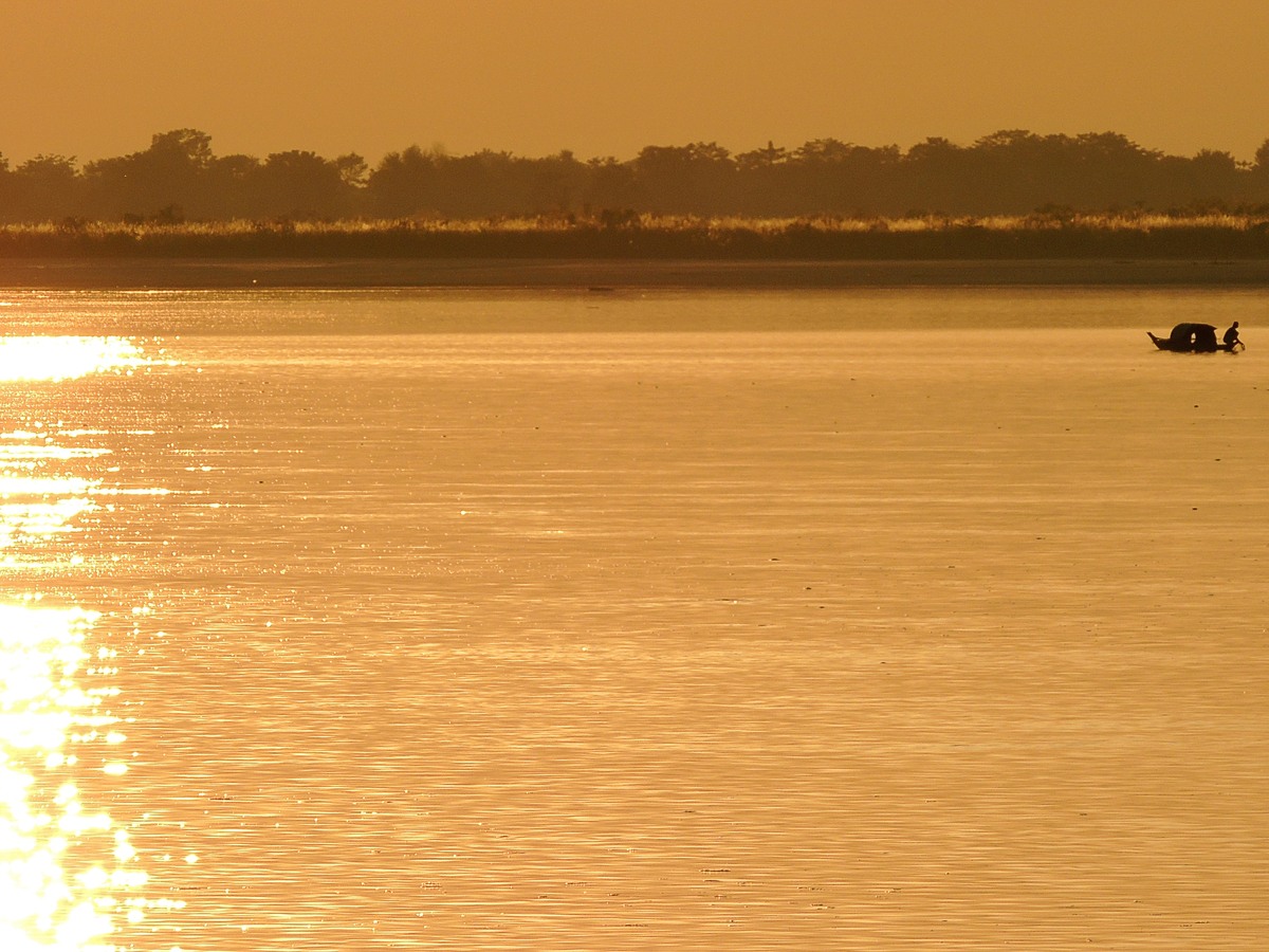 The Brahmaputra glowing gold at sunset