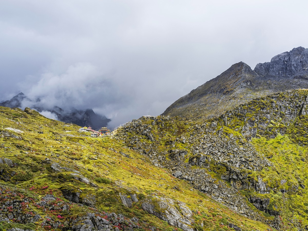 Cloud breaking over a high alpine ridge above the treeline