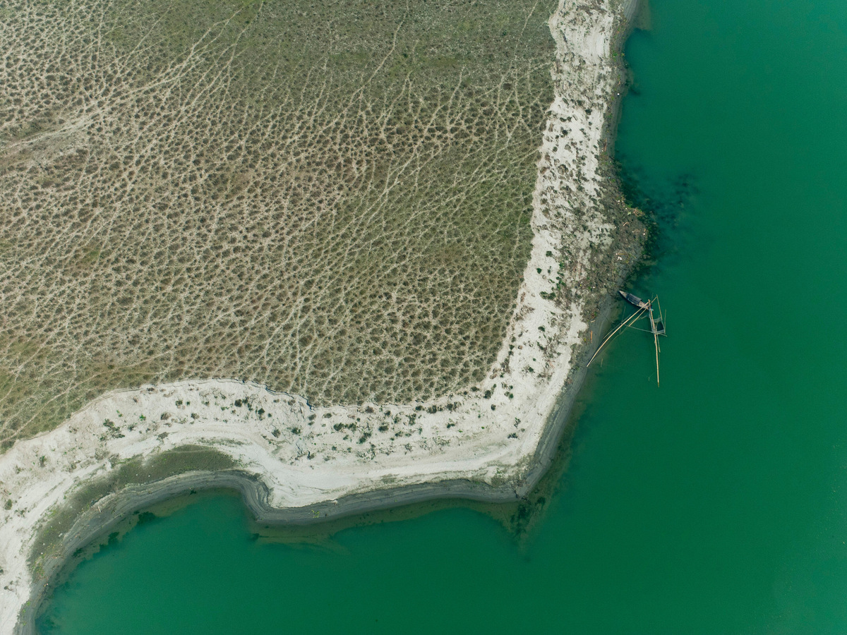 An aerial view of the Brahmaputra curving around a sandbank