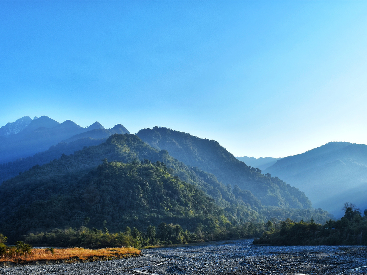 The Dibang river valley below forested mountains near Roing
