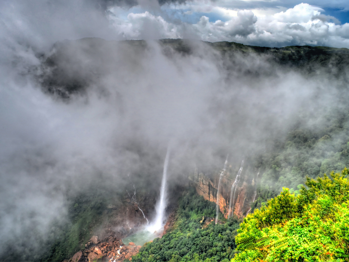 Nohkalikai Falls dropping into a gorge below the clouds