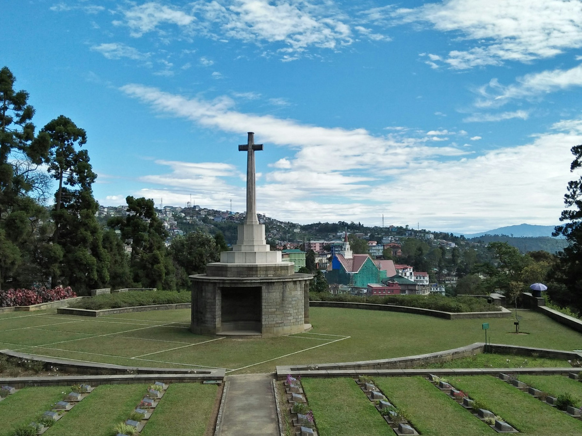 The cross at the Kohima War Cemetery among the hill town’s houses