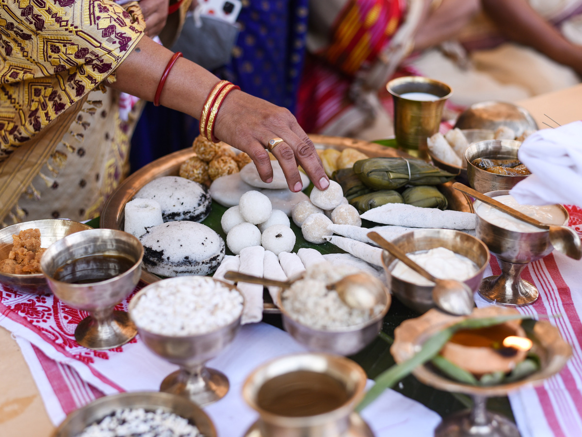 Rice cakes and sweets laid out for a Bihu celebration