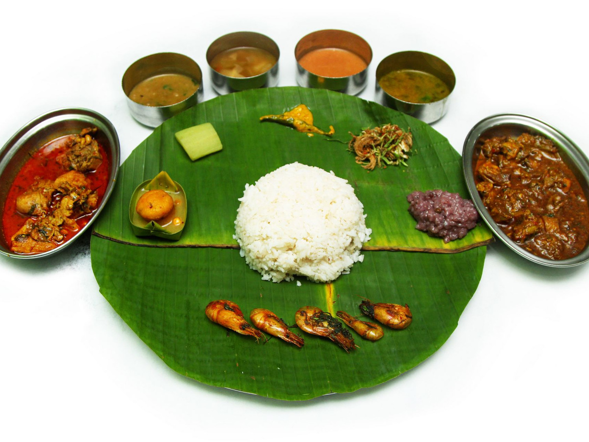 A Manipuri meal served on a banana leaf with many side dishes