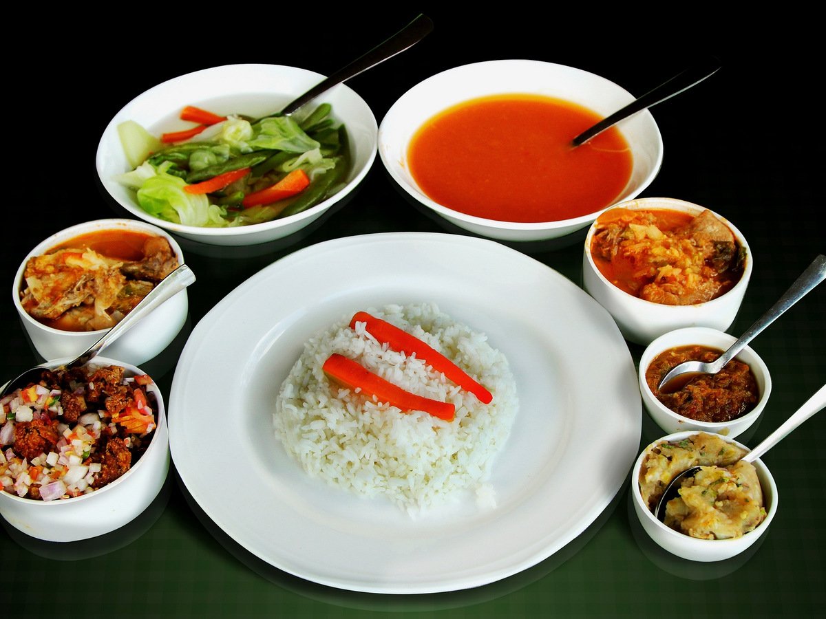 A Naga meal of rice, meat and chutneys in small white bowls