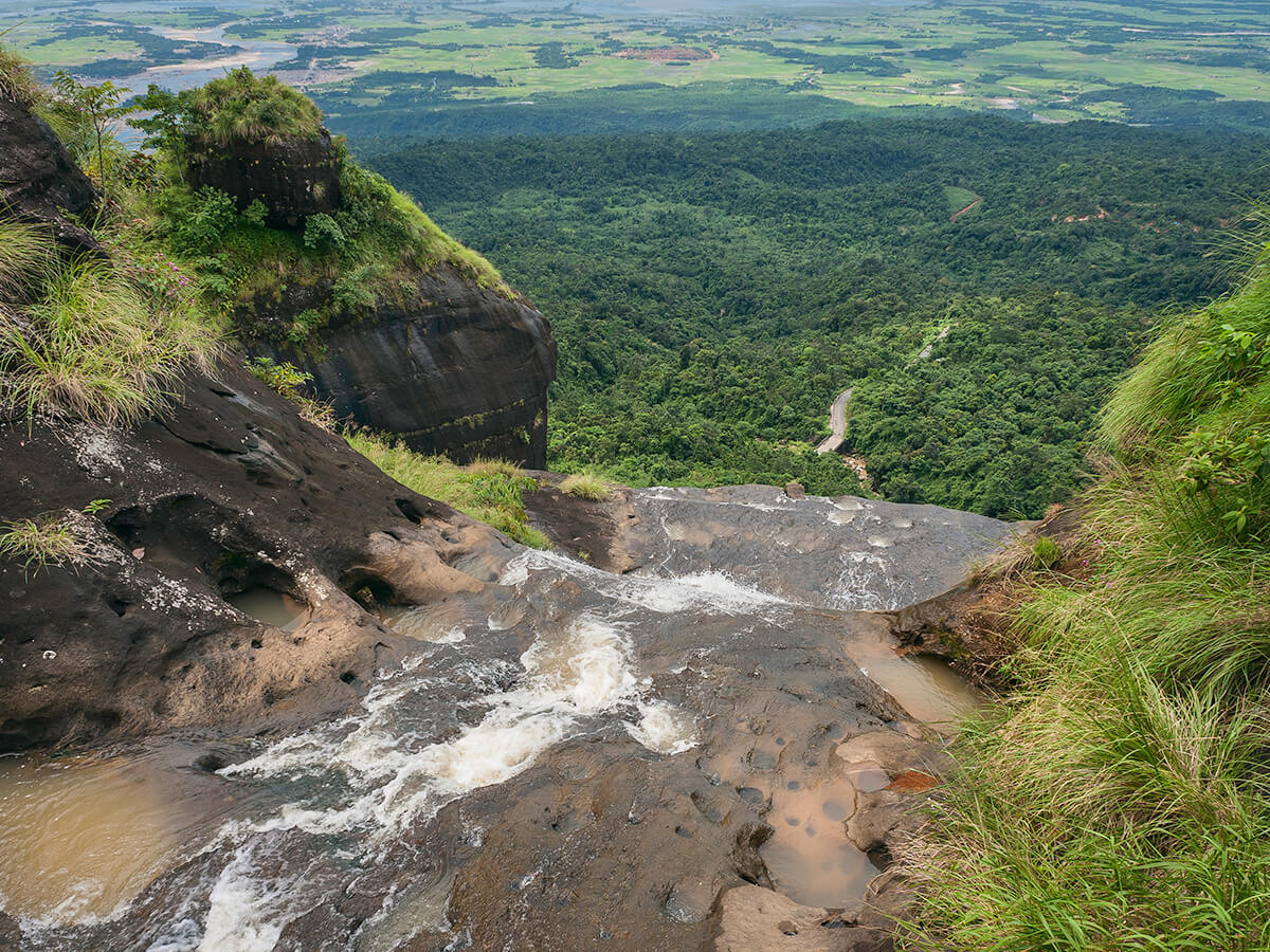 A river running through a green gorge in the hills