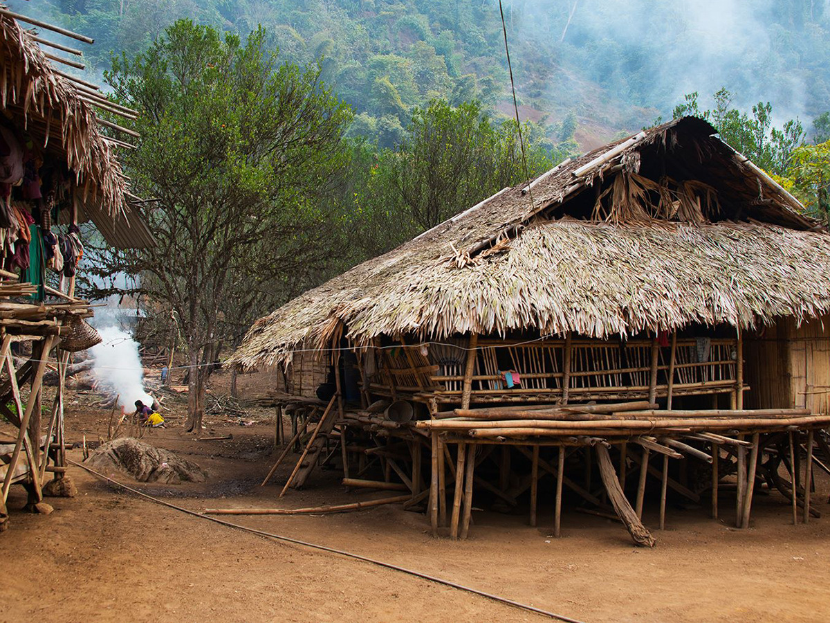 Thatched bamboo houses on stilts in a hill village