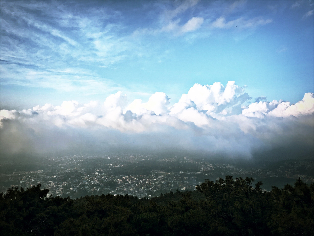 Shillong spread below a bank of white cloud