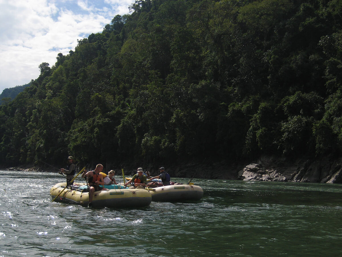Rafts floating down the Subansiri below forested hills