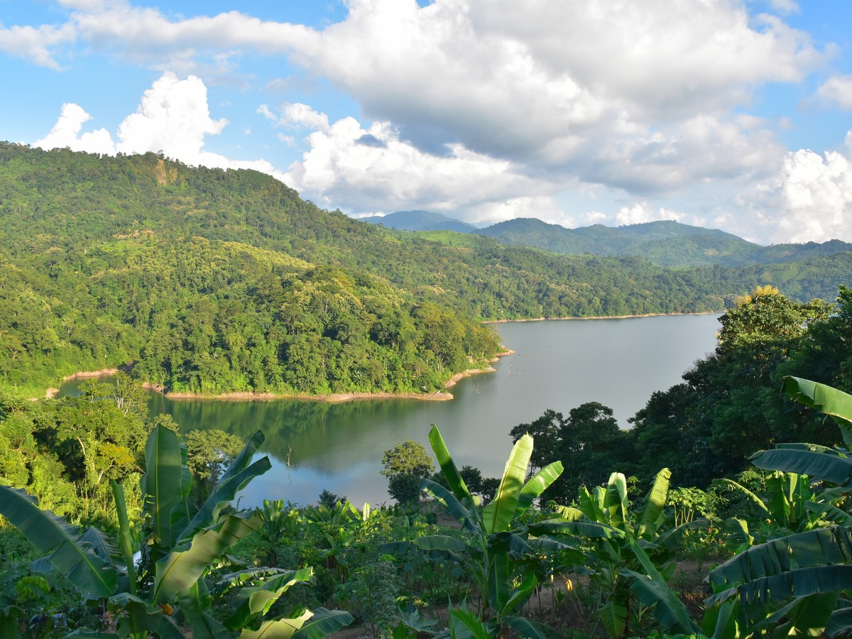 A river winding through forested hills under a big sky