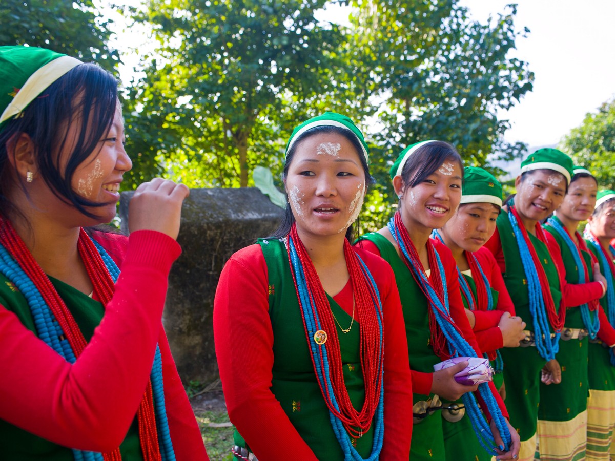 Young women in traditional red dress and bead necklaces