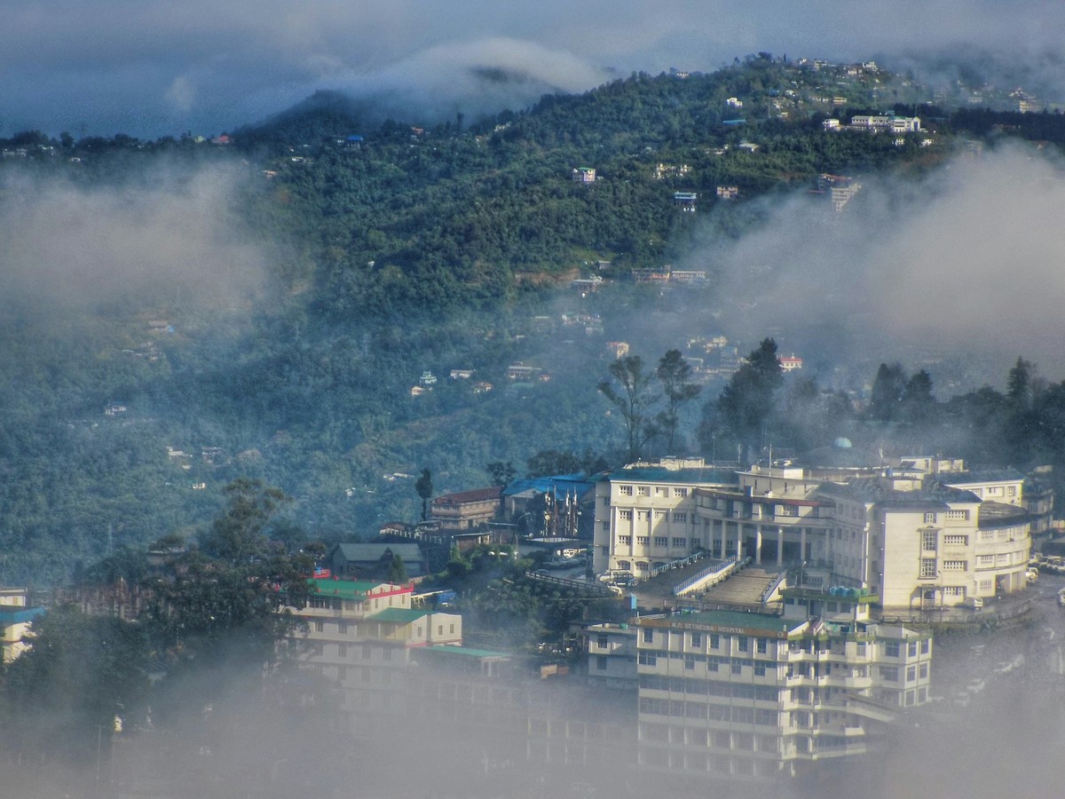 Kohima half hidden in cloud, its buildings stacked up the hillside