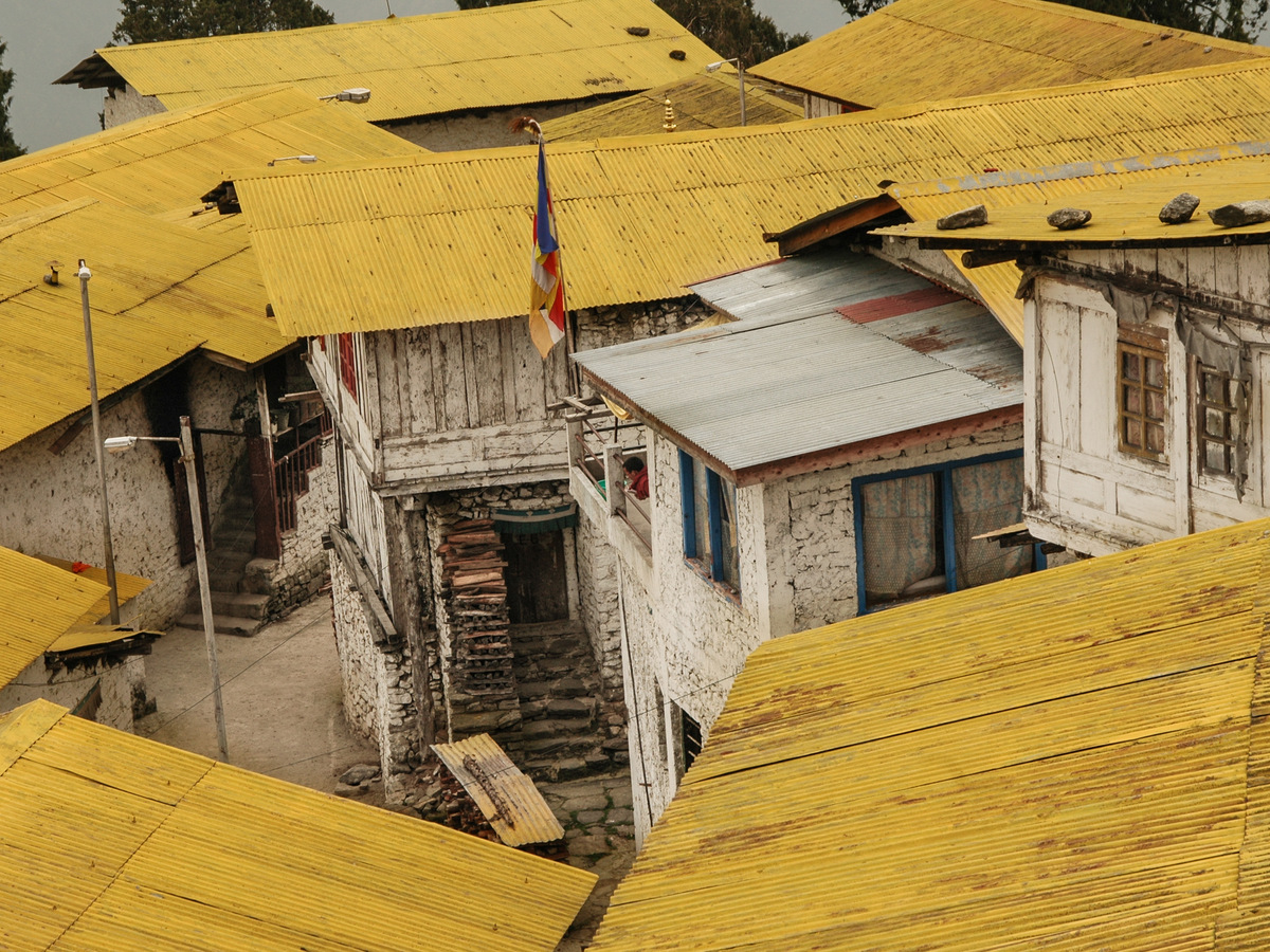 Old wooden houses with yellow roofs in a mountain town